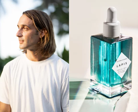 Herbivore co-founder Alex Kummerow in a white t-shirt paired with a bottle of Herbivore Lapis Facial Oil in vibrant blue.