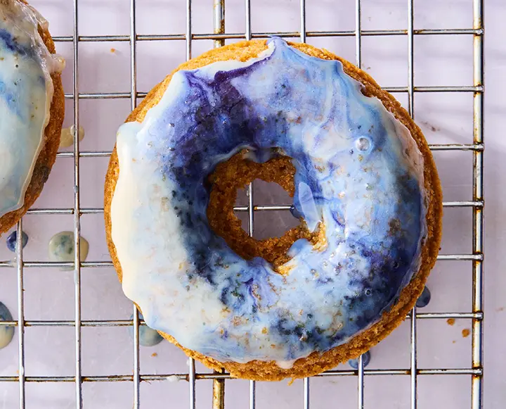 baked vanilla doughnuts with blue magic glaze