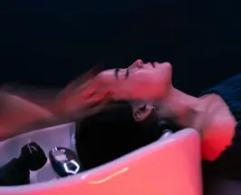 Warm water cascading over a client's hair during the YOLU Sayo head spa ritual in Los Angeles
