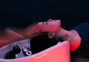 Warm water cascading over a client's hair during the YOLU Sayo head spa ritual in Los Angeles
