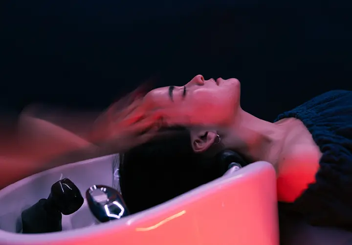 Warm water cascading over a client's hair during the YOLU Sayo head spa ritual in Los Angeles