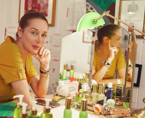 Tata Harper with skincare products at her vanity