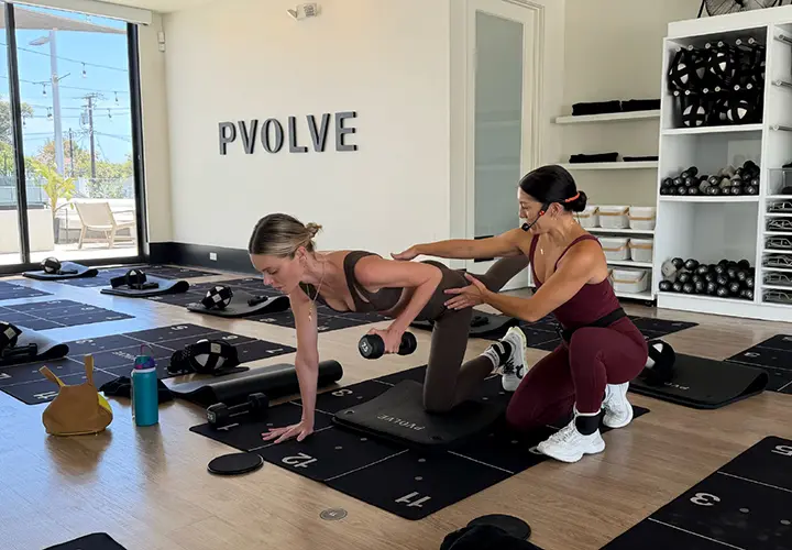 Dani Coleman coaching proper form during a Pvolve strength workout
