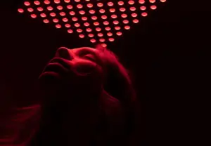Woman receiving red light therapy treatment