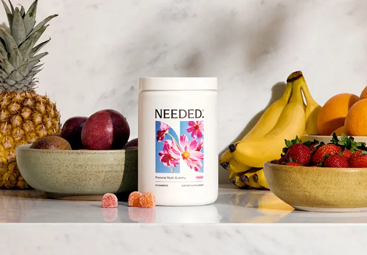 Needed Prenatal Multi Gummy bottle with gummies and fresh fruit