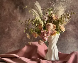 Sullivan Owen sculptural porcelain vase with a romantic floral arrangement