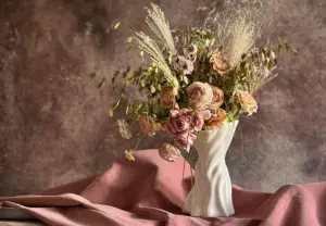 Sullivan Owen sculptural porcelain vase with a romantic floral arrangement
