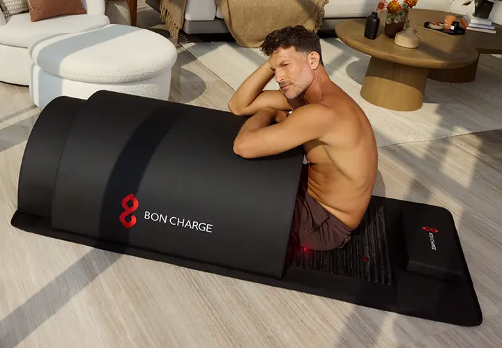 Man using the BON CHARGE Infrared PEMF Sauna Dome at home