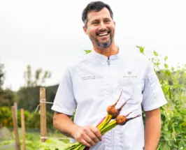Golden Door Executive Chef Greg Frey Jr. holding freshly harvested beets in the garden