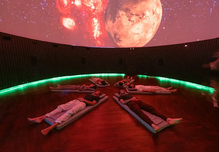 Guests experiencing immersive 4D sound inside the Frequency Dome at The Vessyl